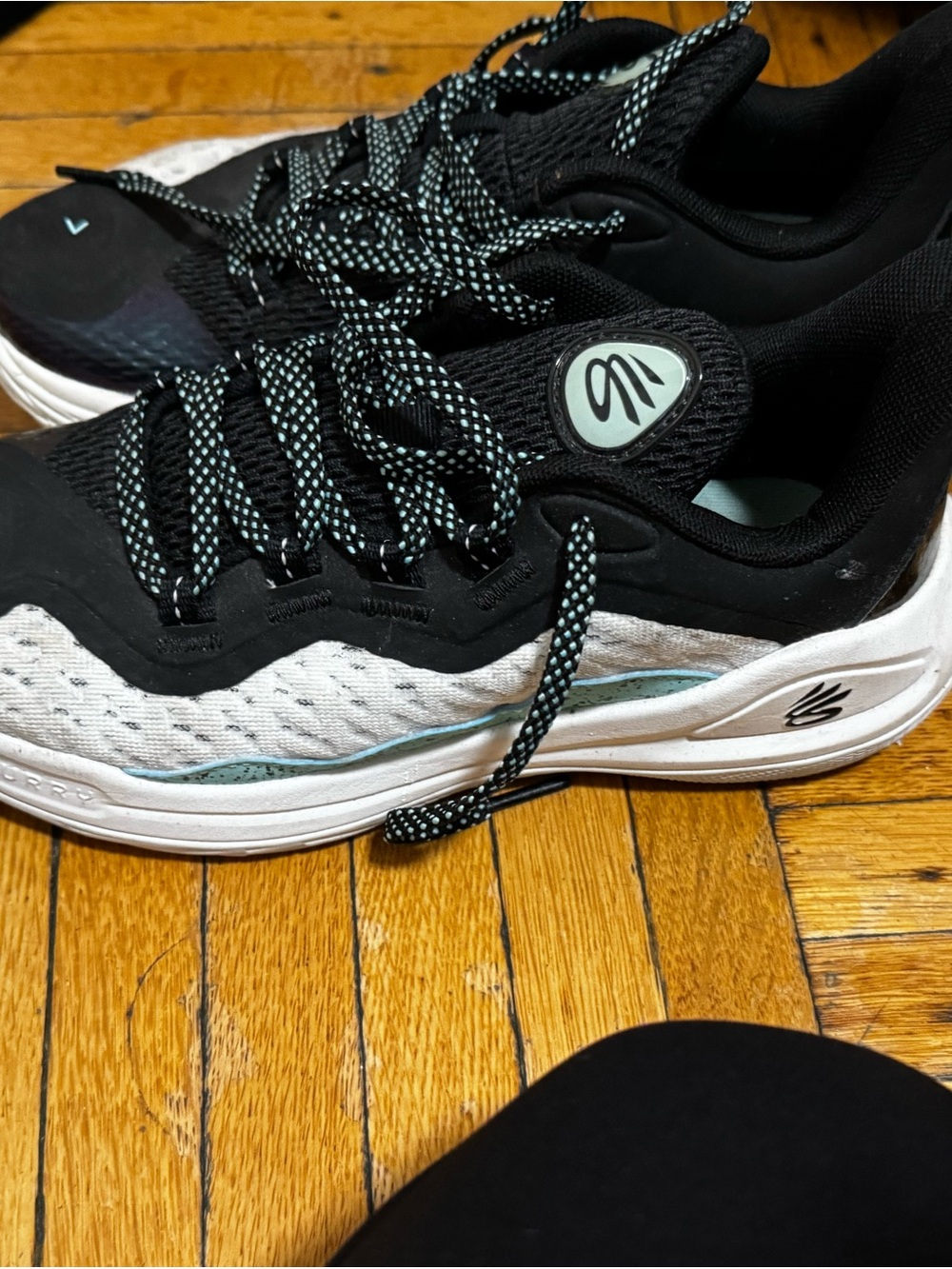 Curry basketball sneaker by Under Armour Kids Black, White & Mint Sneakers.